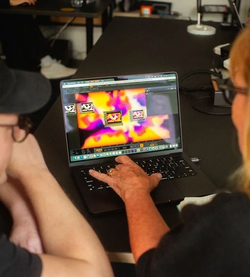 Workshop participants working on a laptop